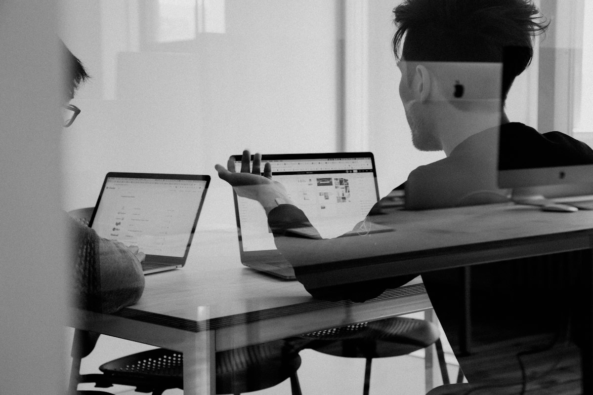 Real estate professional presenting to clients with tablet