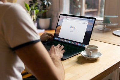 An image depicting a magnifying glass hovering over a computer screen, revealing a detailed graph of website rankings